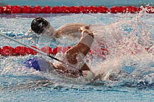 A swimmer with vision impairment is tapped by his coach in Asian Para Games 2018