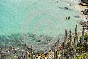 swimmers at beautiful Conchas beach in Arraial do Cabo, Brazil, at summer day