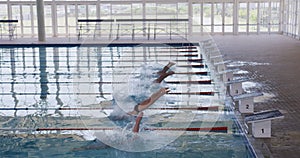 Swimmers diving into the pool