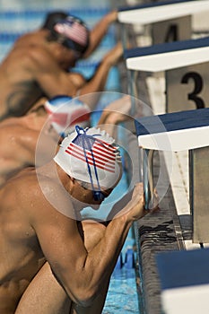 Swimmers Lined Up At Starting Blocks