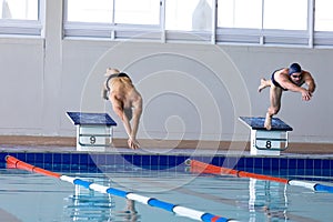 Swimmers plunging in the pool