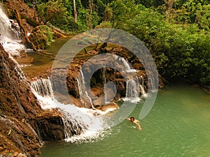 Swimmimg in tourquise Kouang Si Waterfall in Laos photo