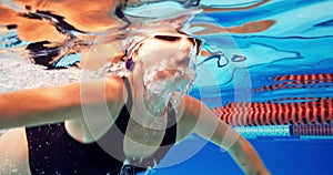 Swimming, athlete and woman in pool with cap for performance training, competition or challenge. Sports, water splash