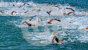 Swimming athletes in a triathlon contest