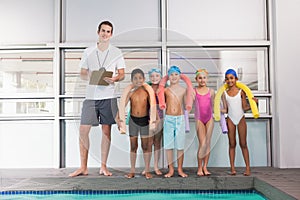 Swimming coach with his students poolside