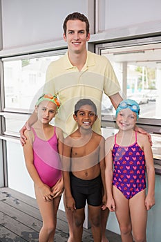Swimming coach with his students poolside