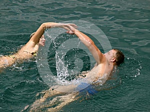 Swimming couple at sea