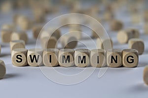 Swimming - cube with letters, sign with wooden cubes