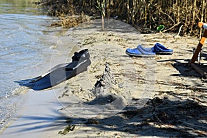 Swimming fins and diving mask on the beach