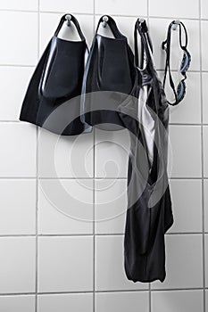 Swimming gear on tile wall
