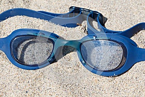 Swimming goggles on a beach
