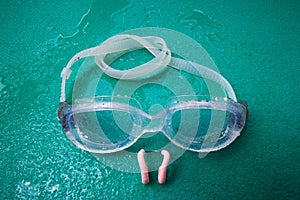 Swimming goggles with nose clip