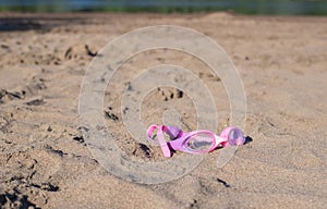 Swimming goggles on sand