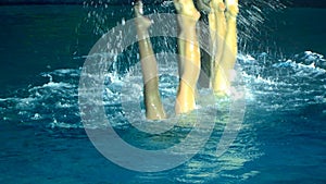 Swimming. A group of girls on the synchronized swimming shows.