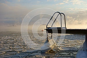 Swimming jetty and buoy in the freezing Baltic Sea in Helsinki, Finland