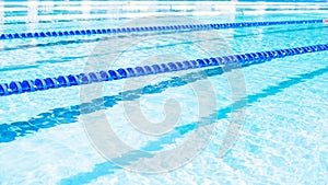 Swimming lanes with clear blue water in public swimming pool in summer