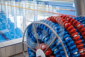 Swimming lanes markers in reel storage, near the pool. Pool lane lines for athletics, swimming.