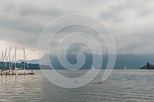Swimming near a docking with boats in the tranquil Lake Lucern