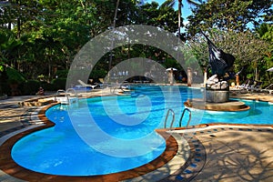 Swimming pol, tropical plants in the grounds of the hotel, Beach and trees, Phra Ae Beach, Ko Lanta, Thailand