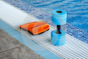 Swimming pool. Accessories for swimming. Board and dumbbell