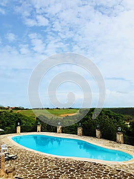 Swimming pool of Altos de Chavon against green lawns and trees photo