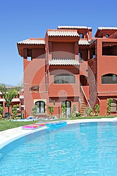 Swimming pool and apartment block on Spanish vacation urbanisation