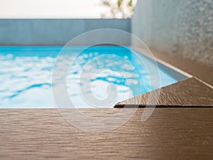 Swimming pool with artificial wood deck