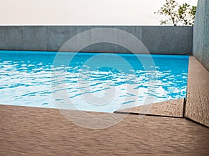 Swimming pool with artificial wood deck