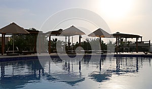 Swimming pool on a background of a sunset, the resort at the Dead Sea, Jordan