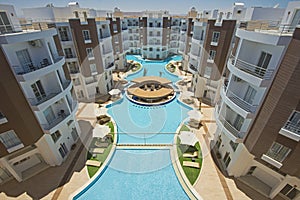 Swimming pool with bar in a luxury tropical hotel apartment resort