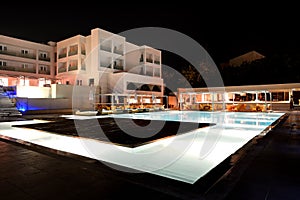 Swimming pool and bar in night illumination