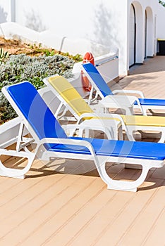 Swimming pool with beach chairs sunbeds