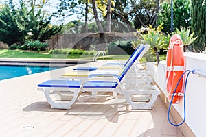 Swimming pool with beach chairs sunbeds