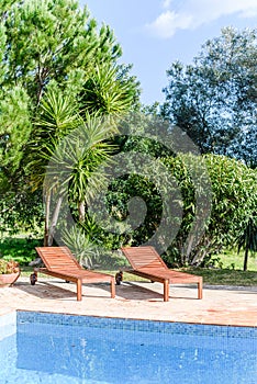 Swimming pool with beach chairs sunbeds