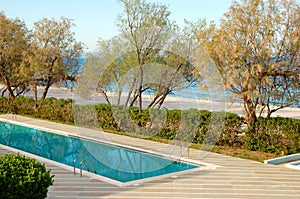 Swimming pool by a beach at the luxury hotel