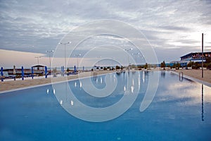 Swimming pool .Beautiful view of Infinity Swimming Pool . cloud reflections on the infinity pool . Luxury outdoors infinity