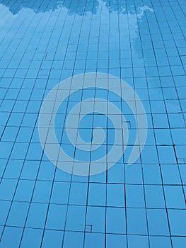 Swimming pool blue water background squard flor
