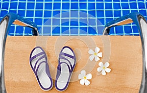 Swimming pool blue water, white plumeria frangipani flowers, women flip flops, poolside, tropical sea beach nature, summer holiday