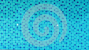 Swimming pool bottom is source tiles and water waves background. Summer texture of water surface