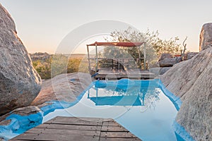 Swimming pool between boulders on a hill at Hoada Camp
