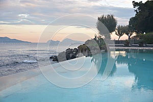 Swimming pool and Capri island landscape sunset sud italy neaples