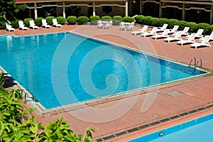 Swimming pool and chaise longues