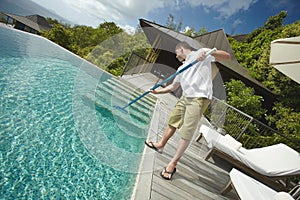 Swimming pool cleaner, professional cleaning service at work.