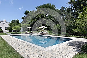 Swimming pool with deck chairs