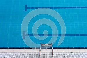 Swimming pool edge with steel ladder