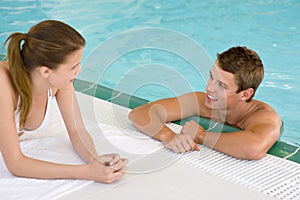 Swimming pool - happy couple chat on poolside