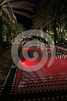 Swimming pool in the hotel with beautiful red lighting at night