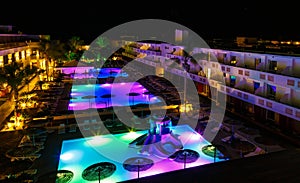 Swimming pool with lighting in spa modern European hotel at night