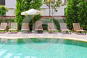 Swimming pool with lounges and parasol.