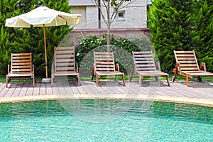 Swimming pool with lounges and parasol.